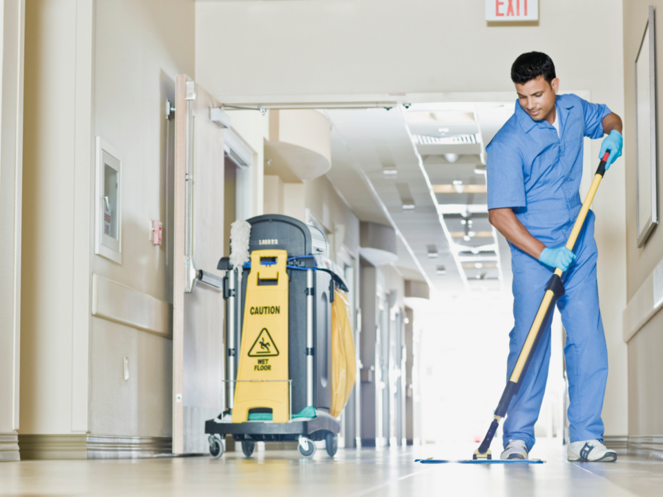 A male mopping the hospital floor