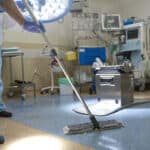 A hospital worker doing cleaning in operation room